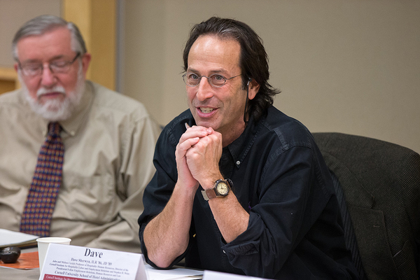 Photo of Professors Dave Sherwyn and Rick Hurd attend a pre-pandemic roundtableable