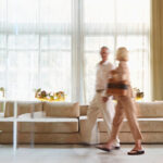 A man and a woman walk through the lobby of a hotel