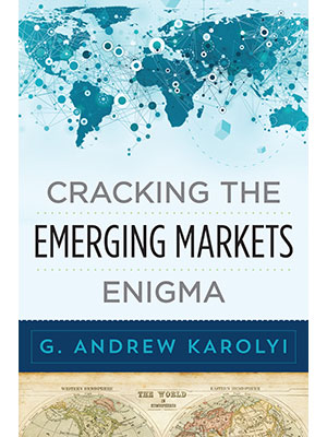 cover of a book by Andrew Karolyi, Cracking the Emerging Markets Enigma, includes a map of the world in the background