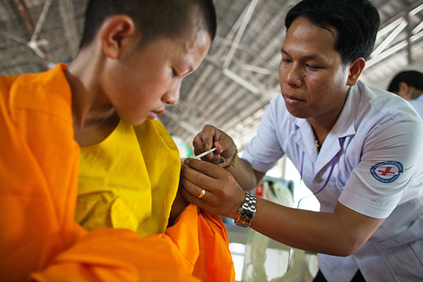 Clinician providing a shot to a young boy