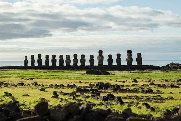 photo of Easter Island, ancient stone statues on a green landscape