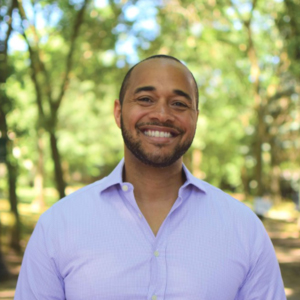 headshot of Omar Blayton with trees in the background