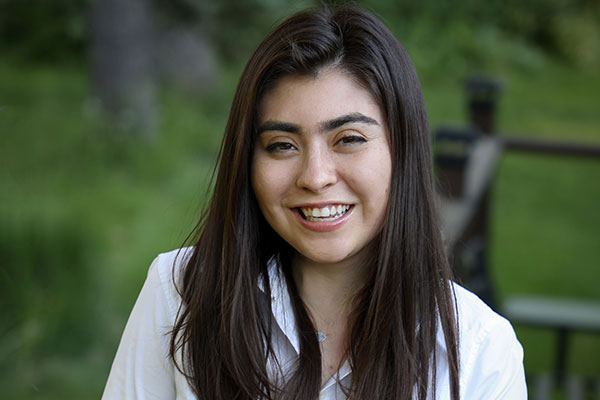 headshot of Marla Beyer, taken outside with green landscape in the background