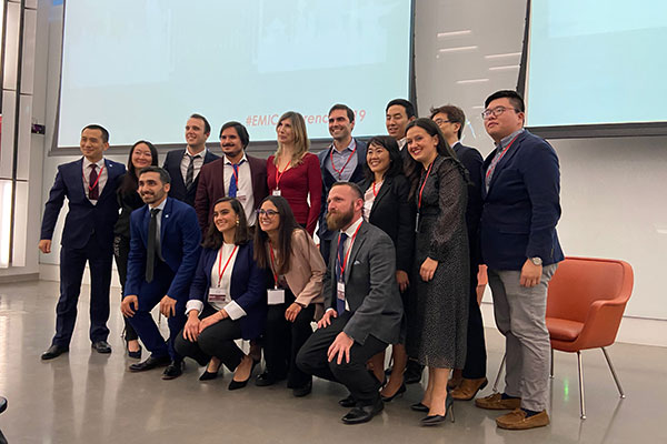 15 student case competition finalists dressed in business attire posing for a picture