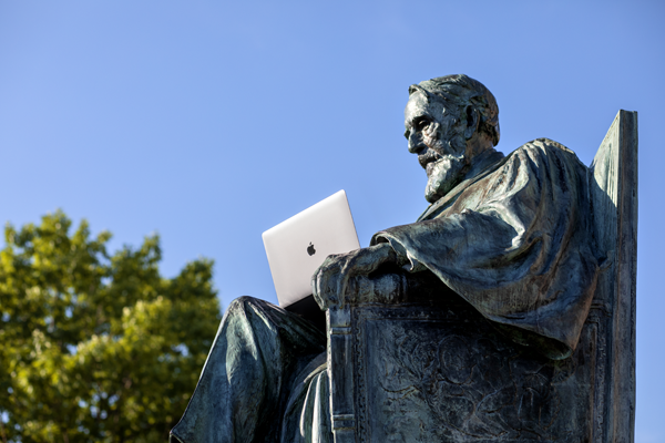 ad white statue with laptop