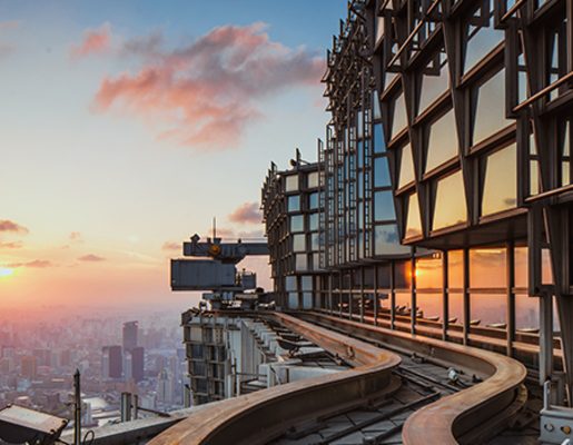 Tall glass building overlooking smoggy skyline