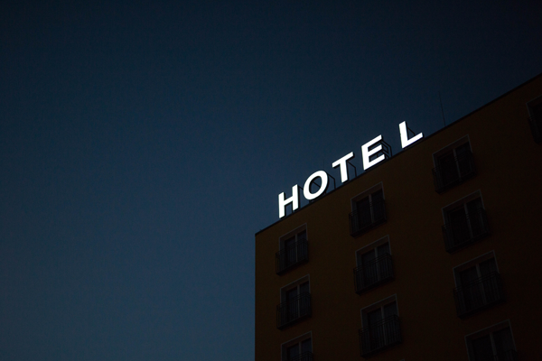 hotel sign lit up at night on building