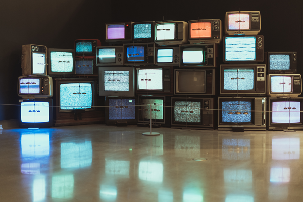 rows of televisions showing static