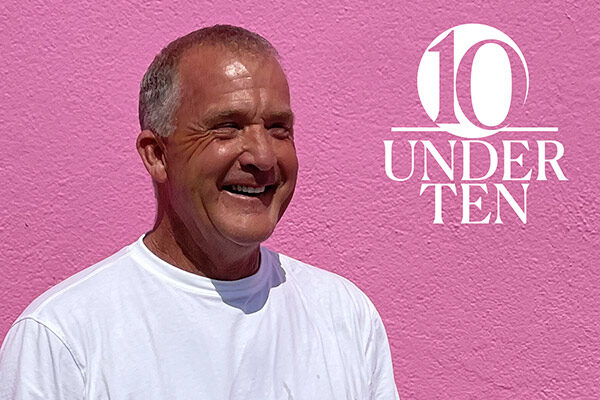 head and torso shot of Bill Dully on a bright pink background next to the 10 Under 10 graphic identifier