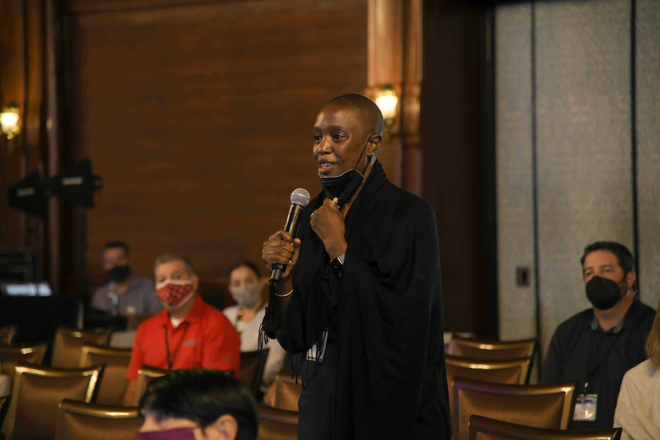 A woman asks a question to the speaker