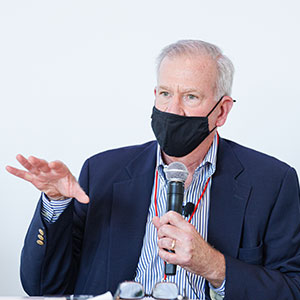 photo of Frank Brown holding a mic and speaking