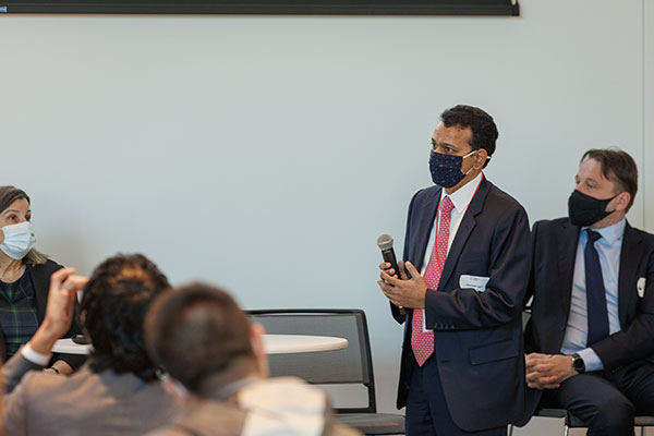 side view of Gautam Jain. addressing the conference audience