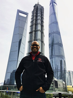 Morgan Jones standing with three glass skyscrapers in the background