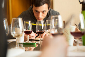 a student examples several glass of wine during a course