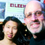 photo of Barry Massarsky and Nari Matsuura standing in front of a theatre marquis.