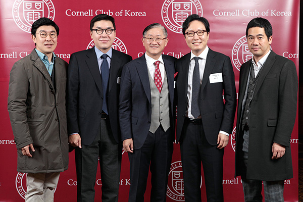 five Korean men standing side by side and smiling with a backdrop in the background showing Cornell University's logo and "Cornell Club of Korea"