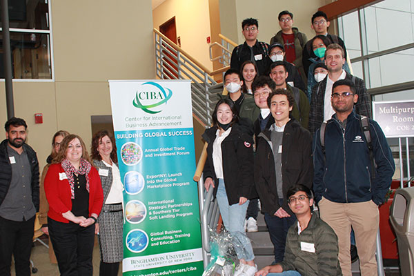 Group photo of students and staff posing with a CIBA banner that also says: "Building Global Success".
