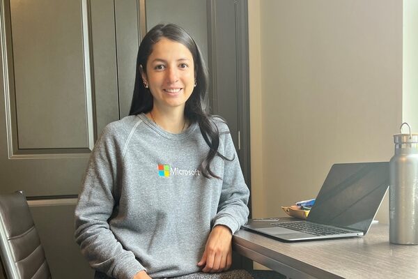 Mariana Flores Aguilar sitting at her desk wearing a gray Microsoft sweatshirt.