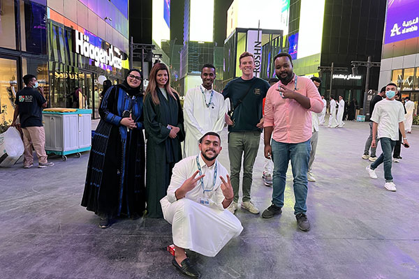 Doug Barnard on a street in Riyadh with several men and women, posing for a photo.