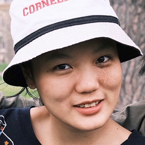 headshot of Joanne Hu wearing a white hat.