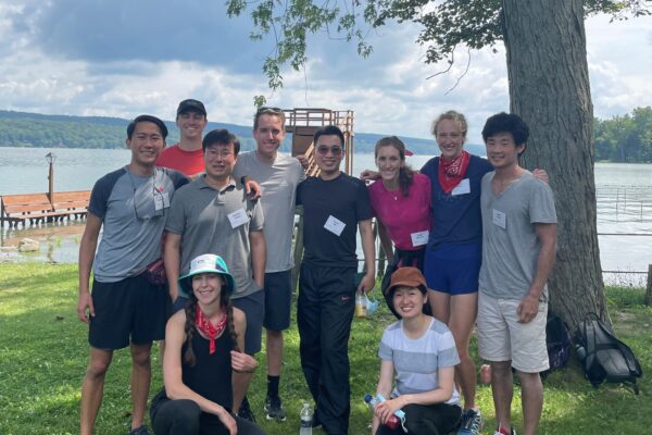 MBA students pose in front of a lake