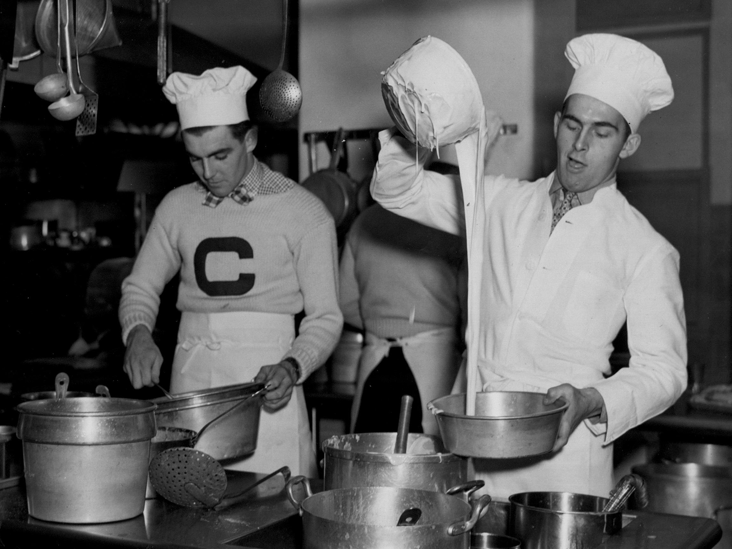 Students in the hotel management course work in the kitchen in the 1920s.
