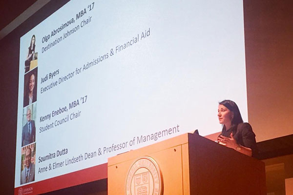 a woman speaking at a podium.