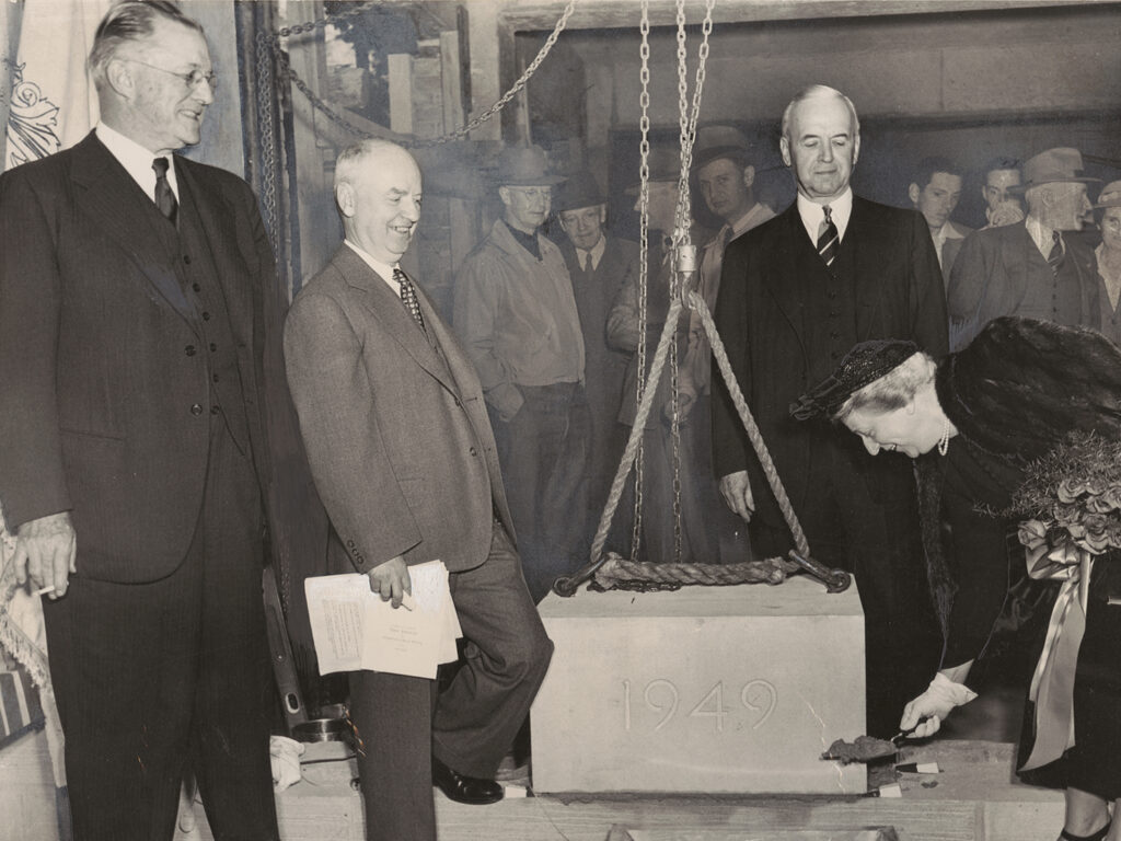 Alice Statler holds a shovel of dirt.