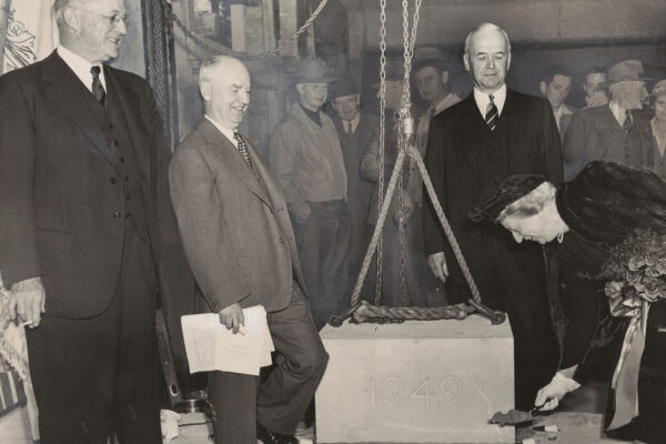 Alice Statler holds a shovel of dirt.