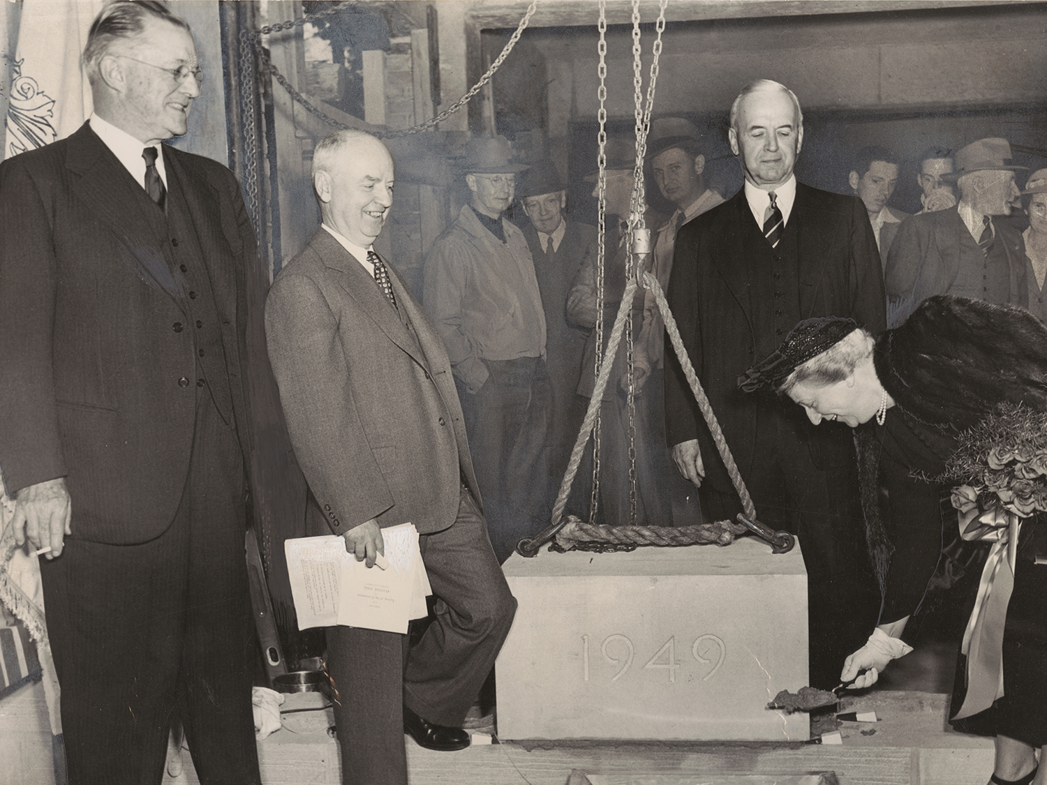 Alice Statler holds a shovel of dirt.
