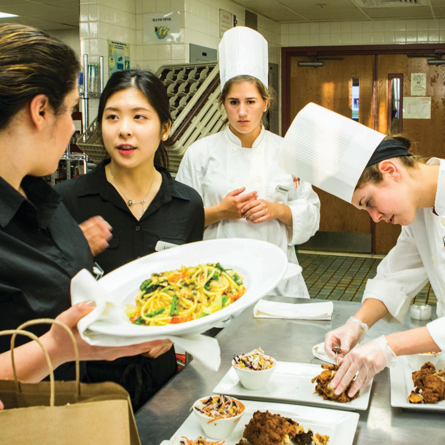 Clockwise: Layal Taher ’16, Lucia Xu ’16, Rebekah Catalana ’16, Elizabeth Huston ’17, Jonathan (Ker Fong) Kwee ’16, and, at back left, Cameron Krane ’17 work their restaurant night.