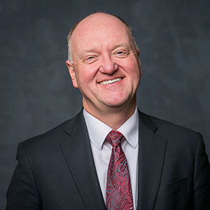 headshot of Andrew Karolyi.