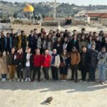 Students on the Israel trek pose for a photo with a view of Jerusalem in the background.