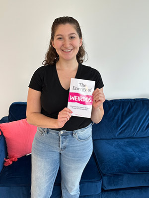 photo of Danielle Boris holding her book, The Energy of Weirdos.