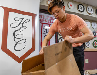 Students break down empty boxes in the HEC offices in preparation for Hotel Ezra Cornell (HEC) 95.