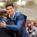 Lucas Suero ’26 hugs fellow competitor Christopher Browne, MPS '23 after winning the 13th annual hospitality business plan competition.