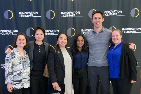 Representatives from Cornell lined up in front of the ClimateCap banner.