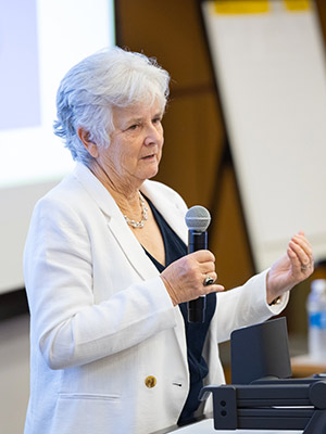 a woman speaking into a microphone.