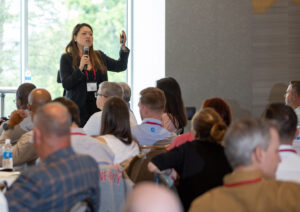 Photo of Lilly Jan presenting to a seated crowd.