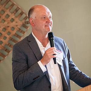 A man standing at a podium and speaking into a microphone.