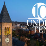 photo of the Cornell clock tower in the foreground and campus in the background below with a blue-sky above, taken in the evening. Stylized text, "10 Under 10," is overlaid on the photo.