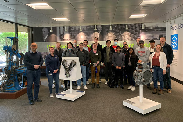 Group photo of Vishal Gaur with about 20 students in a room with manufacturing machinery on display.