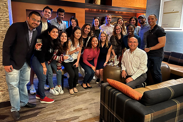 Group photo of Vishal Gaur with group of students and alumni in a living room or lounge area.