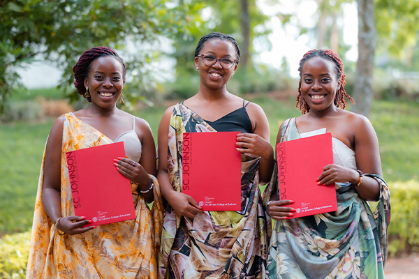 Three graduate women in Rwanda.
