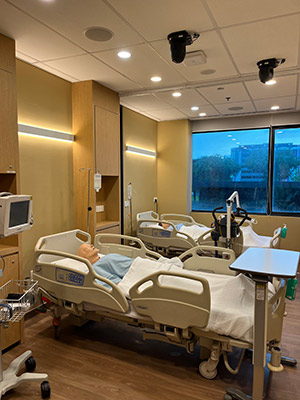 photo of a hospital room with medical mannequins for training in hospital beds.