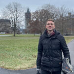 Gergely Keményfi standing on the Cornell Arts Quad earing a down jacket.