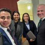 four students in business attire