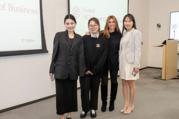 Three women and coach on case competition team