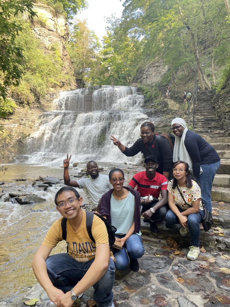 STARS Fellows pose in front of waterfall on Cascadilla Gorge Trail