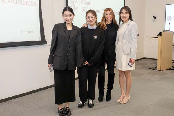 Four female students in a classroom.